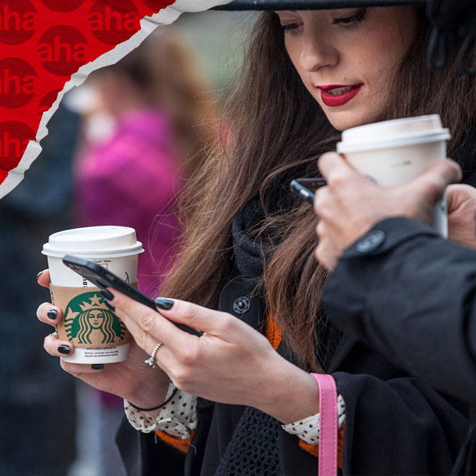 Woman holding Starbucks cup and phone